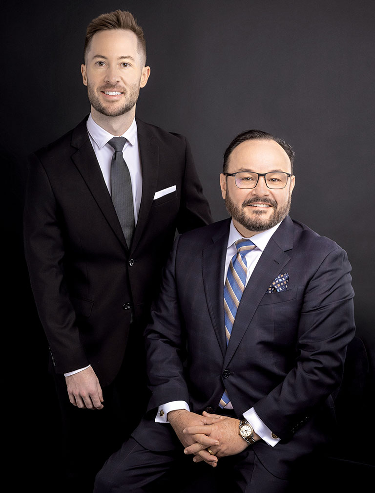 Dr. Scott Ogley and Dr. Aldo Guerra together wearing suits