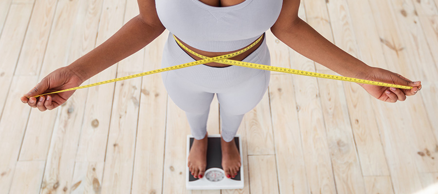Woman on scale measuring waist