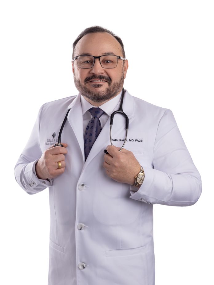 Dr. Aldo Guerra wearing a white lab coat with stethoscope