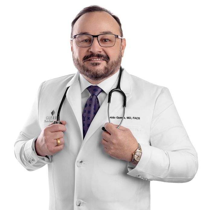 Dr. Aldo Guerra wearing a white lab coat with stethoscope