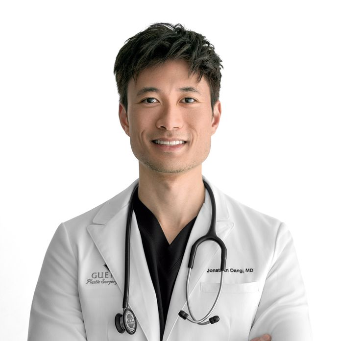 Dr. Jonathan Dang wearing a white lab coat with stethoscope