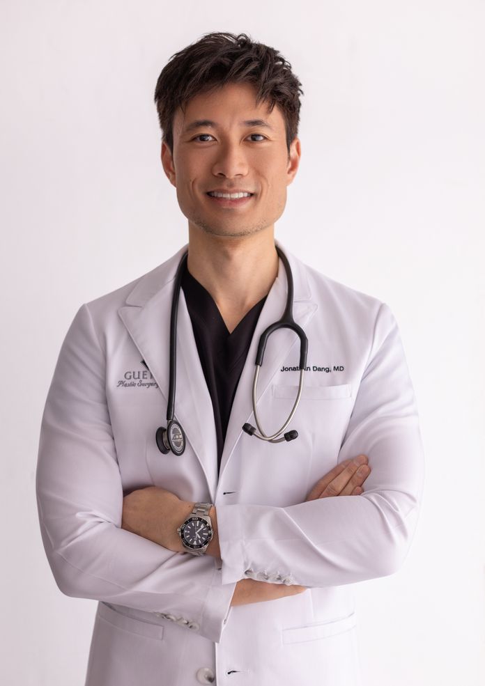 Dr. Jonathan Dang wearing a white lab coat with stethoscope